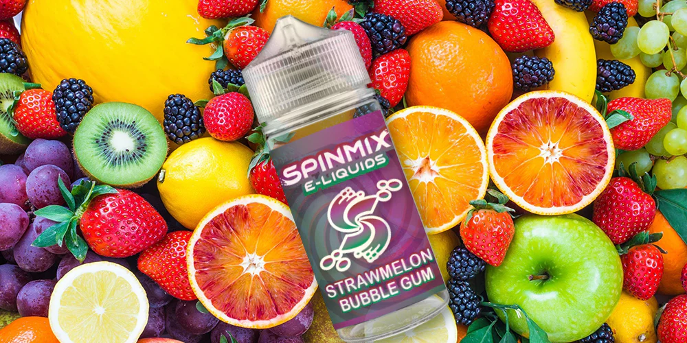 Assorted bottles of fruit-flavored vape juices surrounded by strawberries, mangoes, blueberries, and other fresh fruits.